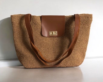 May include: A brown woven tote bag with leather straps and a leather flap closure with a gold metal clasp.