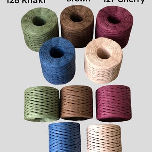 May include: Assortment of 10 spools of paper twine in various colors, including khaki, dark brown, cherry, indigo blue, and salmon. Each spool is labeled with a number and color name.