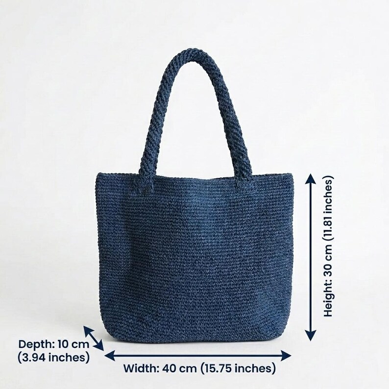 May include: A dark blue woven tote bag with two braided handles. The bag measures 15.75 inches in width, 11.81 inches in height, and 3.94 inches in depth. The texture is consistent throughout the body and handles, featuring a dense, uniform weave.