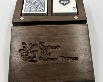May include: A dark wooden poker tray with two card compartments. One contains a deck with a blue floral pattern, the other shows an Ace of Spades. The tray is engraved with "Splash Pot Poker Trays".