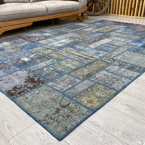 May include: A blue and brown patchwork rug with a variety of patterns and textures. The rug is made from recycled materials and is perfect for adding a touch of bohemian style to any room.