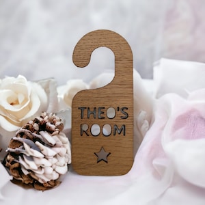 May include: Wooden door hanger with the text "Theo's Room" and a star cutout. The hanger is brown and has a hook at the top.