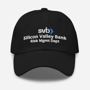 May include: Black baseball cap with white embroidered text that reads "svb> Silicon Valley Bank Risk Mgmt Dept."