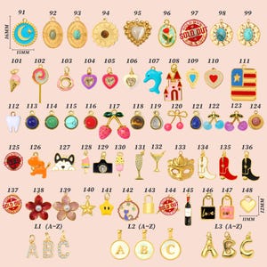 May include: A collection of gold-toned charms and pendants in various shapes, including hearts, stars, and flowers. Some charms feature colorful enamel details, gemstones, and text. Sizes vary, with some measuring 16mm and 12mm in height.