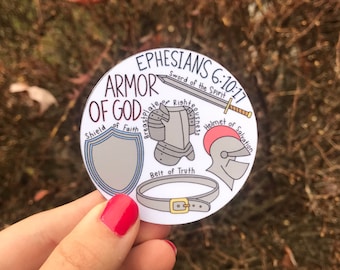 May include: A white circular sticker with a black outline and the text "EPHESIANS 6:10-17 ARMOR OF GOD" in black. The sticker features a drawing of a knight's armor with the words "Sword of the Spirit", "Breastplate of Righteousness", "Helmet of Salvation", "Shield of Faith", and "Belt of Truth" written around the armor.