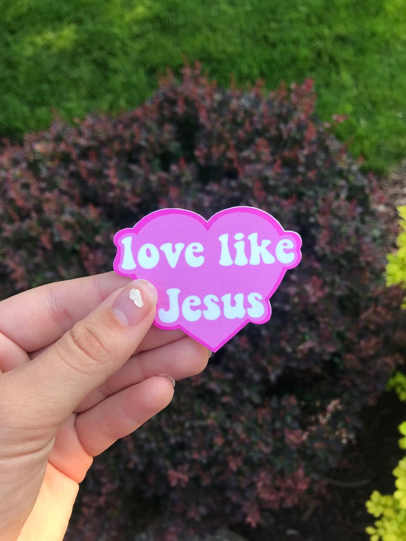 May include: Pink heart-shaped sticker with the text "love like Jesus" in white lettering.