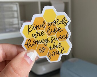 May include: A yellow and white honeycomb-shaped sticker with the text "Kind words are like honey, sweet to the soul".