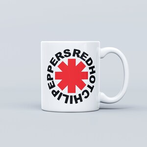 May include: White ceramic mug with a red starburst logo and the text "Red Hot Chili Peppers" in black.