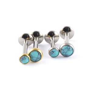 May include: Three pairs of silver and gold body jewellery with turquoise stones. The jewellery is designed for piercings and has a flat back.