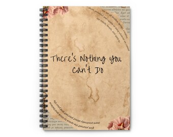 May include: Spiral-bound notebook with a vintage-style cover. The cover is a tan color with a distressed look and the text "There's Nothing you can't Do" in black. Floral accents and inspirational text are also present.