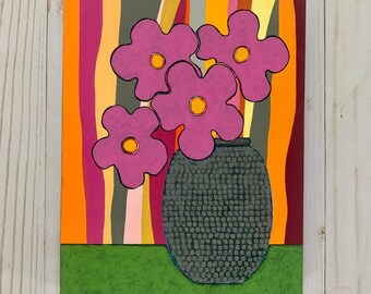 May include: A painting of a gray vase with a textured surface filled with pink flowers with yellow centers. The vase is sitting on a green surface in front of a background of colorful stripes.