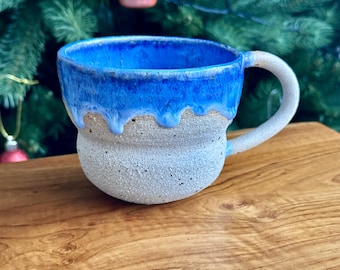 Handmade ribbed mug with blue droplets, made from speckled clay.