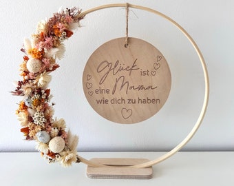 Wooden disc in a ring with dried flowers and engraving for Mother's Day