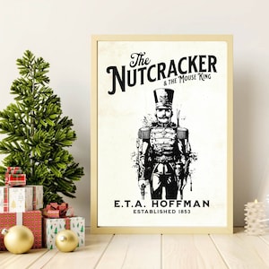 May include: A black and white illustration of a Nutcracker soldier with a large hat and a mustache. The text "The Nutcracker & The Mouse King" is above the soldier and "E.T.A. Hoffman Established 1853" is below the soldier. The background is a light beige.
