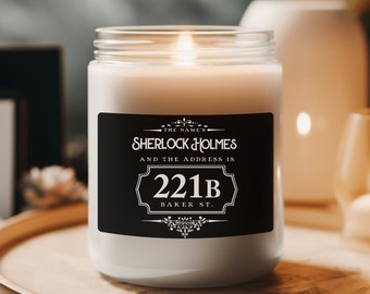 May include: A white candle with a black label that reads "The Name's Sherlock Holmes and the address is 221B Baker St."