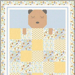 May include: A baby quilt with a brown bear applique in the center. The quilt is made of yellow, blue, and white fabric with a variety of patterns, including polka dots, stars, and animals. The quilt is surrounded by a border of brown bears, cars, and stars.