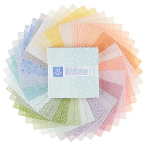 May include: A collection of pastel-colored fabric squares arranged in a circular pattern. The squares feature various patterns, including polka dots and stripes. A central stack of squares is wrapped with a label that reads "little Kimbies". The fabric is likely intended for quilting or crafting.