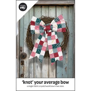 May include: A decorative bow made of patchwork fabric featuring a grid of squares in red, green, white, and grey with various patterns, attached to a circular brown twig wreath. The text 'knot' your average bow and a Studio M logo are visible.