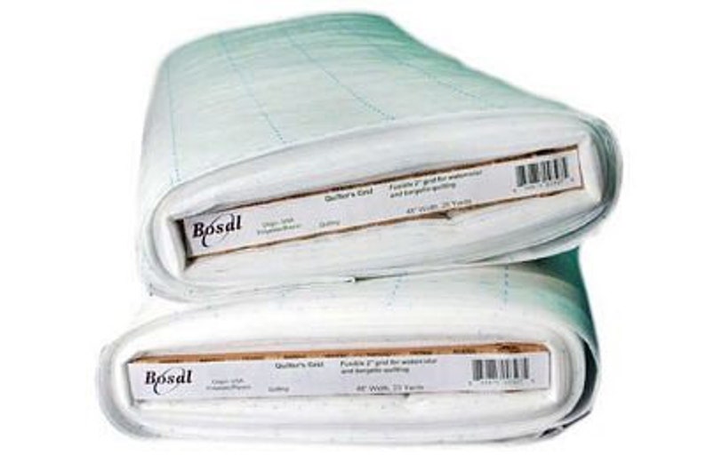 May include: Two rolls of white quilting fabric with a grid pattern. Each roll has a label that reads "Bosal" and includes text about the product's use for watercolor and serging quilting. The fabric is 48 inches wide and 25 yards long.