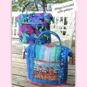 May include: A sewing pattern for a Poppins bag by Aunties Two Patterns, featuring two quilted bags with handles. One bag has a floral print in blue, pink, and black, while the other features a beach scene with three figures and blue tones.