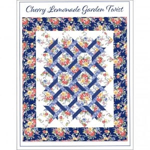 May include: A floral quilt with a white background and a blue lattice design. The quilt features a border of blue floral fabric and the text "Cherry Lemonade Garden Twist" at the top. The quilt's center has a repeating pattern of floral squares.