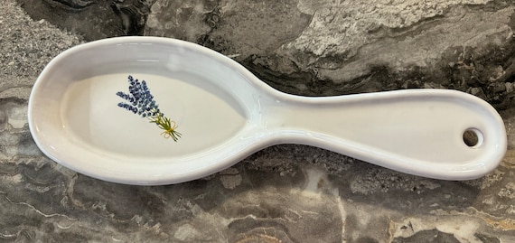 A lavender floral terracotta spoon rest that's genuinely pretty and practical — 17 favorites confirms real demand for this sweet little handpainted piece.