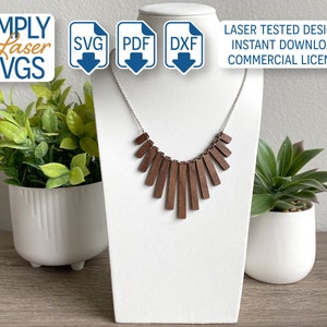 May include: A wooden necklace with a geometric design. The necklace is made of brown wood and has a silver chain. The necklace is displayed on a white mannequin. The image also includes the text "SIMPLY Laser SVGS", "SVG", "PDF", "DXF", "LASER TESTED DESIGNS", "INSTANT DOWNLOAD", and "COMMERCIAL LICENSE".
