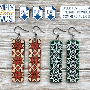 May include: Four wooden earrings with a geometric pattern. Two earrings are red and white, and two earrings are green and white.