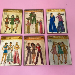 May include: Six vintage Simplicity sewing pattern envelopes featuring different designs for clothing. The patterns are from the 1970s and feature women's clothing.