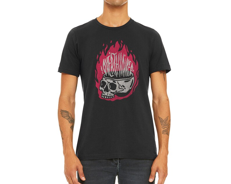 May include: Black t-shirt featuring a graphic of a skull with flames emerging from its head. The text "Overthinking" is written on the flames.