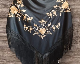 Black Spanish shawl with gold floral embroidery.