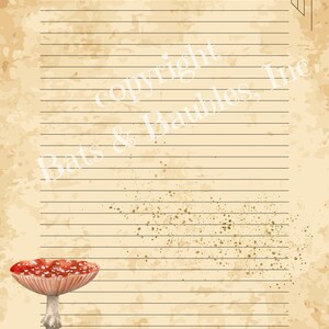 May include: A vintage-style lined paper sheet with a red and white mushroom illustration. The paper has a distressed, aged look with brown and gold splotches.