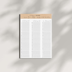 Könnte beinhalten: Ein weißer 75-Tage-Tracker-Notizblock mit einem Deckblatt aus Kraftpapier. Der Notizblock enthält ein Raster aus Kreisen zur Gewohnheitsverfolgung, mit dem Text "75 Medium Tracker" oben. Der Notizblock ist für die Gewohnheitsverfolgung konzipiert.