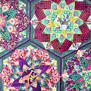 May include: A colorful patchwork quilt with geometric patterns and animal motifs. The quilt features a variety of fabrics in shades of purple, pink, green, and yellow. The design includes zebras and giraffes.