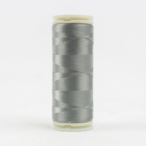 May include: A spool of gray thread with a white plastic bobbin.