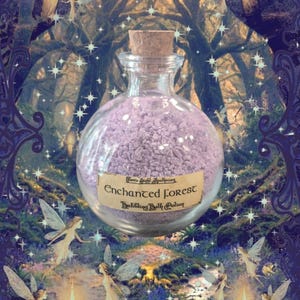 May include: A clear glass round bottle with a cork stopper filled with light purple bath salts. A beige rectangular label on the front features the text "Faerie Light Apothecary" and "Enchanted Forest Bubbling Bath Potion" in black font.