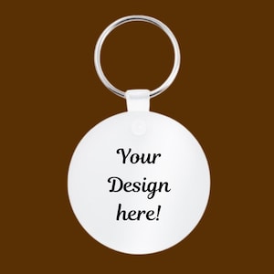 May include: White round keychain with a silver ring. The keychain has the text "Your Design here!" printed on it.