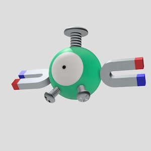 Könnte beinhalten: Ein grünes und weißes Spielzeug mit einem großen Auge und drei silbernen Schrauben. Zwei silberne Hufeisenmagnete mit roten und blauen Akzenten sind an den Seiten befestigt.