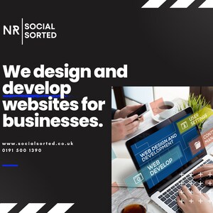 May include: A laptop computer with a black screen displaying the text "Web Design and Development" and "Web Develop". The laptop is on a table with a cup of tea and a person's hand holding a smartphone.