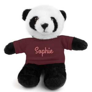 May include: A plush panda bear wearing a maroon t-shirt with the name "Sophie" embroidered in pink.