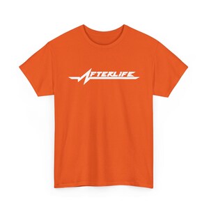 May include: Orange t-shirt with the word "AFTERLIFE" in white, stylized with a heartbeat-like graphic. The shirt is a solid orange color and has short sleeves.