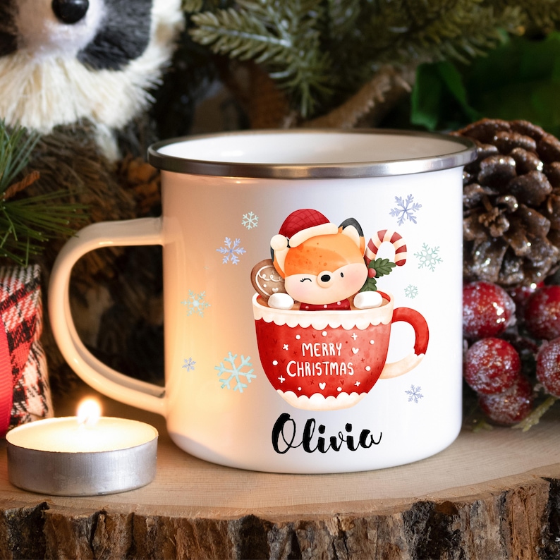 May include: White enamel mug with a red and white illustration of a fox in a mug with the text "Merry Christmas" and the name "Olivia" printed on the bottom.