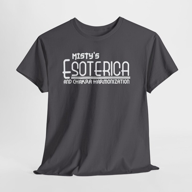 Peut inclure: T-shirt gris fonc&eacute; avec le texte blanc "Misty's Esoterica and Chakra Harmonization". Le t-shirt a des manches courtes et un col rond. Le texte est dans une police stylis&eacute;e.