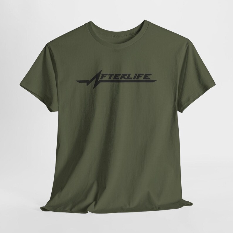 May include: Olive green t-shirt with the word "AFTERLIFE" in black, stylized with a heartbeat-like graphic. The short-sleeved shirt is made of a soft material.