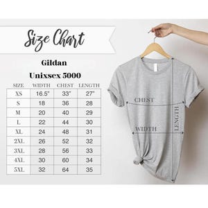 May include: A light gray Gildan Unisex 5000 t-shirt hanging on a wooden hanger. The image includes a size chart with measurements in inches for width, chest, and length, ranging from XS to 5XL.