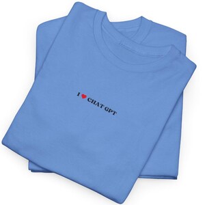 May include: A folded blue t-shirt with the text "I &hearts; CHAT GPT" printed on the front.