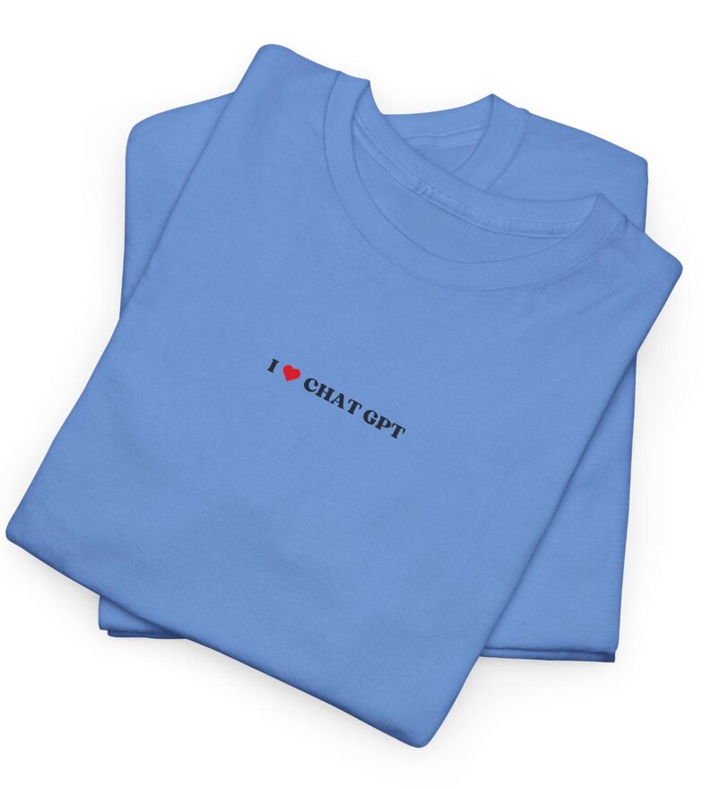 May include: A folded blue t-shirt with the text "I &hearts; CHAT GPT" printed on the front.