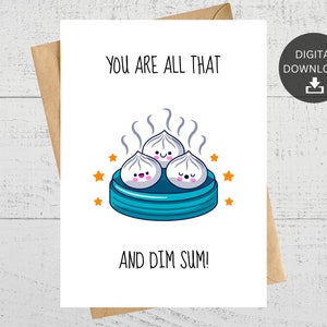 May include: A white card with the text "You are all that and dim sum!" in black. A cartoon illustration of three steamed buns with happy faces in a blue steamer basket with orange stars.