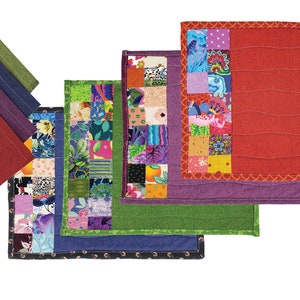 May include: Set of six quilted placemats in various colors and patterns. The placemats are made of fabric and have a quilted design. The placemats are arranged in a row, with the largest placemat at the top and the smallest placemat at the bottom.