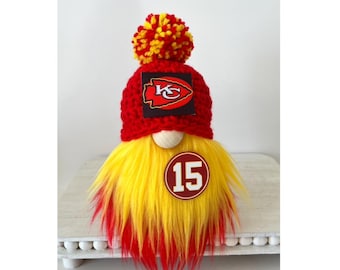 May include: A red and yellow gnome with a red hat featuring the Kansas City Chiefs logo and the number 15.
